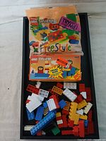 Two boxed Lego System sets and loose Lego bricks, showing packaging and brick variety.
