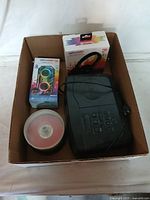 Full box containing the Sony radio cassette player, Art & Sound Cyber Sync box, headset box, and spindle of blank discs.