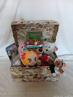 Full view of decorative trunk open showing all included plush toys