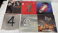 Six 12-inch vinyl LP record album covers displayed showing the set of records included in the lot.