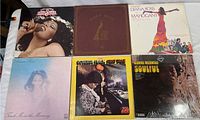 Photo showing six 12-inch vinyl LP album covers by Donna Summer, Diana Ross, Roberta Flack, and Dionne Warwick arranged in two rows of three. Albums appear vintage with varied colors and artwork.