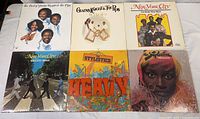 Six vintage 12 inch LP records arranged in two rows with colorful album covers featuring Gladys Knight & The Pips, New York City, and The Stylistics.