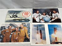 Pearl Harbor Story book with colored photos of astronauts and rocket launches spread out on white background.