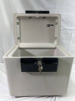 Front view of the fire file safe open, showing empty interior and keys in lock.