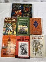 Photo of all 8 books showing front covers, displaying titles and condition of each book.