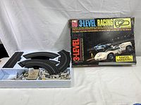 Box and track pieces laid out in original styrofoam insert showing contents and condition.