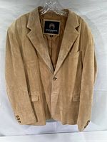 Front view of beige leather jacket with classic two-button closure and three pockets