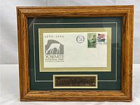 Framed commemorative envelope and stamp with plaque in wooden frame.