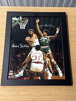 Full view of black wood framed photo showing basketball action with signatures