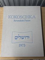 Front of beige cloth portfolio case with title text