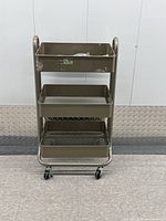 Front view of 3-tier metal rolling cart showing surface wear and bent caster