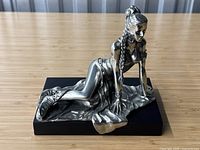 Front view of kneeling Princess Leia figurine on black base