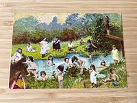Front of the postcard showing children swimming in a pond or natural pool.