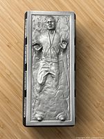 Top view of pewter lid showing Han Solo frozen in carbonite relief