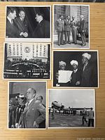 Six black-and-white press photographs laid out on wood surface showing various UN sessions and delegate meetings.