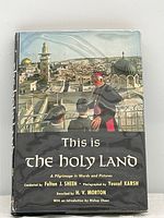 Front cover of book with dust jacket featuring a religious figure overlooking the cityscape.