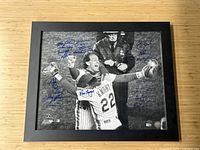 Framed black-and-white photograph of Ray Knight hugging Gary Carter on the field, displaying multiple blue ink signatures