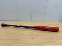 Full-length view of bat from handle to barrel on tabletop