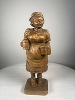 Front view of the wood carved figurine showing woman holding beer glasses
