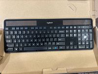 Top-down view of Logitech solar powered wireless keyboard showing full keys and solar panels.