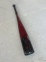 Full view of Rawlings 27 inch baseball bat with visible red to black gradient and Rawlings 5150 model marking.