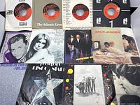 Assorted Atlantic-label 45 RPM records in paper sleeves and several picture sleeves featuring artists including Mick Jagger.