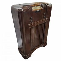 Left angled view showing entire wooden radio with rounded edges and vertical slats at front bottom.