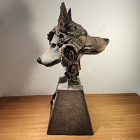 Side profile of the wolf sculpture showing detailed fur texture and realistic features.