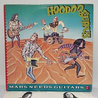 Front cover of 'Mars Needs Guitars!' LP showing cartoon band members playing instruments on a sand-colored background