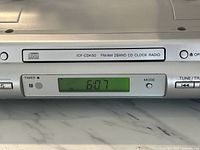 Close-up of front display showing digital clock and model label.