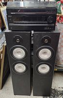 Composite image showing the Onkyo TX-NR535 AV Receiver stacked below a Nikko NP100 turntable and a pair of black MTS floor-standing speakers.
