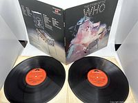 Double vinyl records with gatefold cover open, showing front and back artwork of 'The Story of The Who' by Polydor.