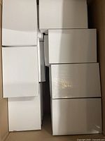 Stack of multiple white retail jewelry boxes showing exterior.