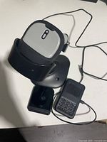 Barcode scanner on stand with cable visible; for identification of scanner model and condition