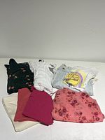 Full view of the bundle items displayed folded on a white surface showing various colors and styles