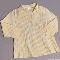 Yellow stripe vintage button down top laid flat showing collar and sleeve length