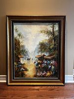 Full view of framed oil painting leaning against wall