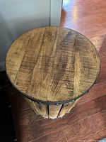 Top view showing wood grain surface and round shape.