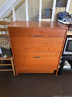 Front view of the cherry stained two drawer wooden file cabinet with black handles