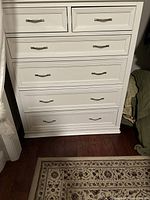 Full front view of white chest showing 2 small top drawers and 4 lower drawers