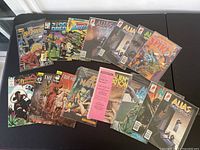 Top view of laid out comic books showing various titles and cover art in fair condition