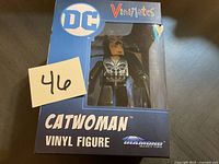 Photo of the boxed Catwoman vinyl figure showing the front of the packaging with DC and Vinimates logos.