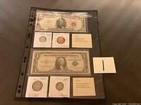 Collection laid out in protective sleeves, showing bills and coins with corresponding labels.