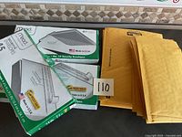 Lot showing three Mead Security Envelope boxes and a stack of Secura padded yellow envelopes.