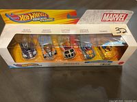 Front of the Hot Wheels Racer Verse Marvel 5-car boxed set showing cars labeled Black Panther, Rocket Raccoon, Captain Marvel, Captain America, Thor