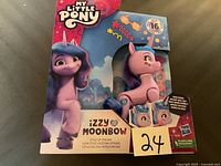 New My Little Pony Izzy Moonbow figure in packaging with 16 styling accessories.
