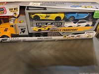 Photo of boxed Forza Motorsport Vehicle Transport toy set featuring large yellow transport truck and three sports cars inside the packaging.