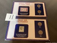 Photo of two framed collectible plaque sets, each featuring historical U.S. stamps and pennies from mid-1900s.
