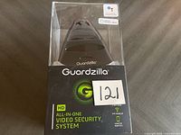 Front view photo of Guardzilla video security system in original sealed packaging showing branding and features.