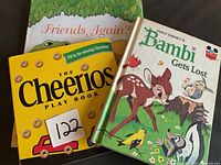 Two copies of Walt Disney's Bambi Gets Lost and The Cheerios Play Book, stacked showing front covers.